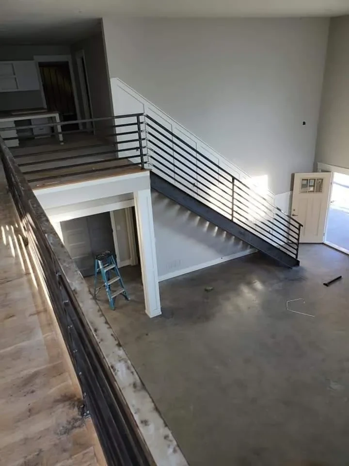 Custom steel staircase and horizontal railing installed in new home